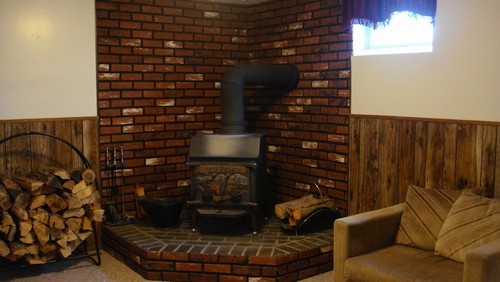 family room wood burning stove and brick foundation.