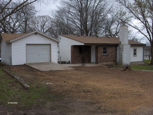 back of house oversized single garage with opener.  covered patio.
