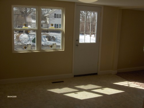 dining area new flooring, windows, and front door.