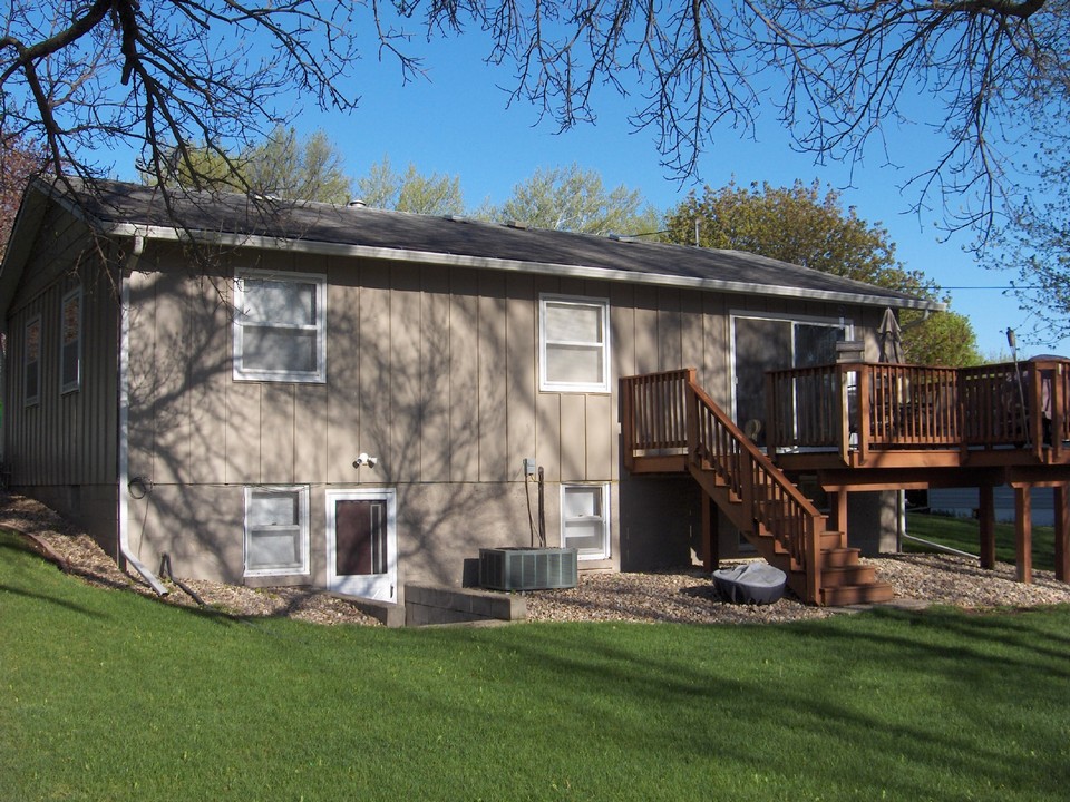 back of house nicely landscaped, walk out basement, deck off of living room, newer central air