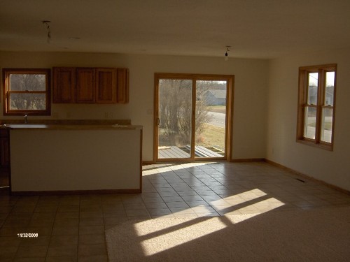 dining area ceramic tile is on the floor in the kitchen and the dining area.  a walk out patio door leads you to the 2 decks.