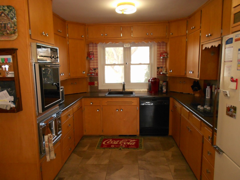 kitchen new flooring, sink, and backsplash.  lots of cupboards.