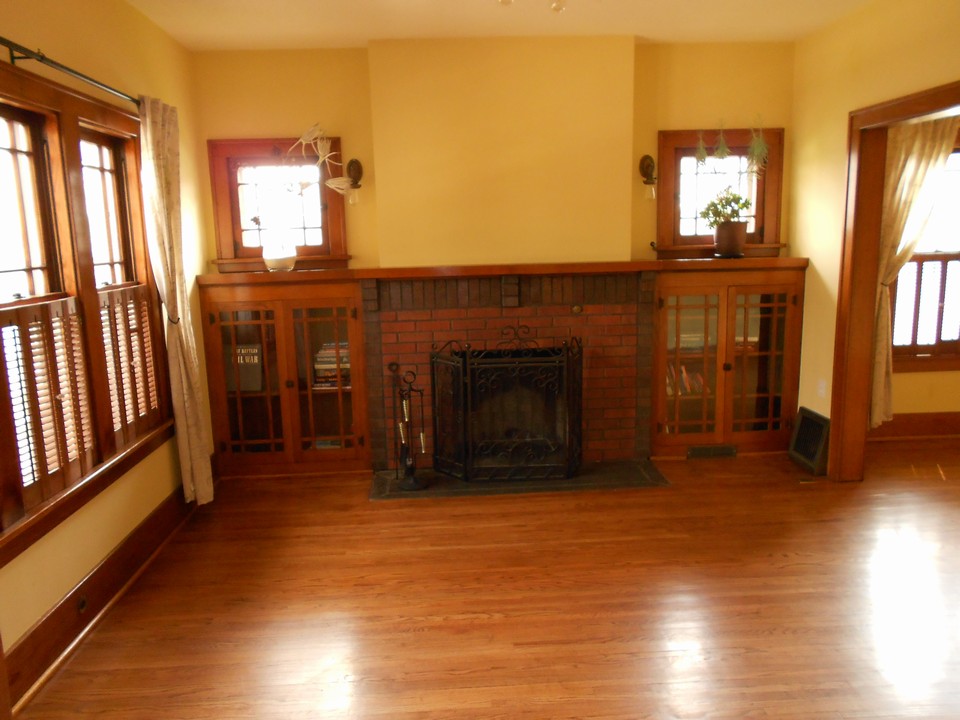 living room and fireplace character windows and built in display case