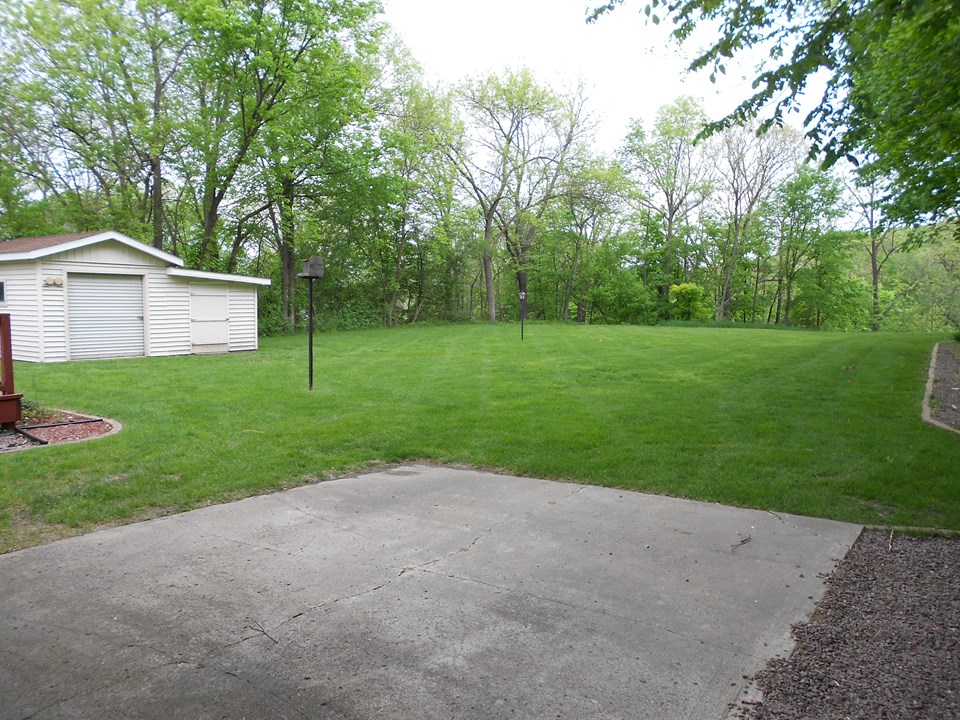 backyard 2 sheds, patio, deck, flat yard.