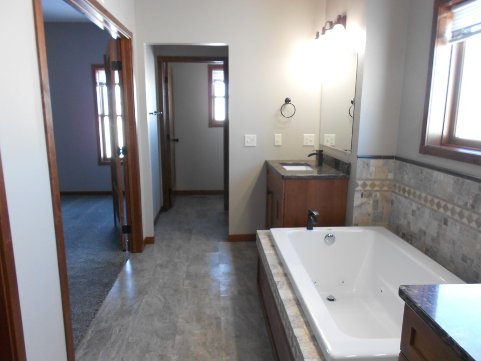 master bathroom tiled jacuzzi and walk in shower. dual sinks.