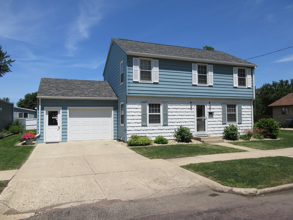 front of home nice curb appeal with new roof, nice siding, nice landscaping.