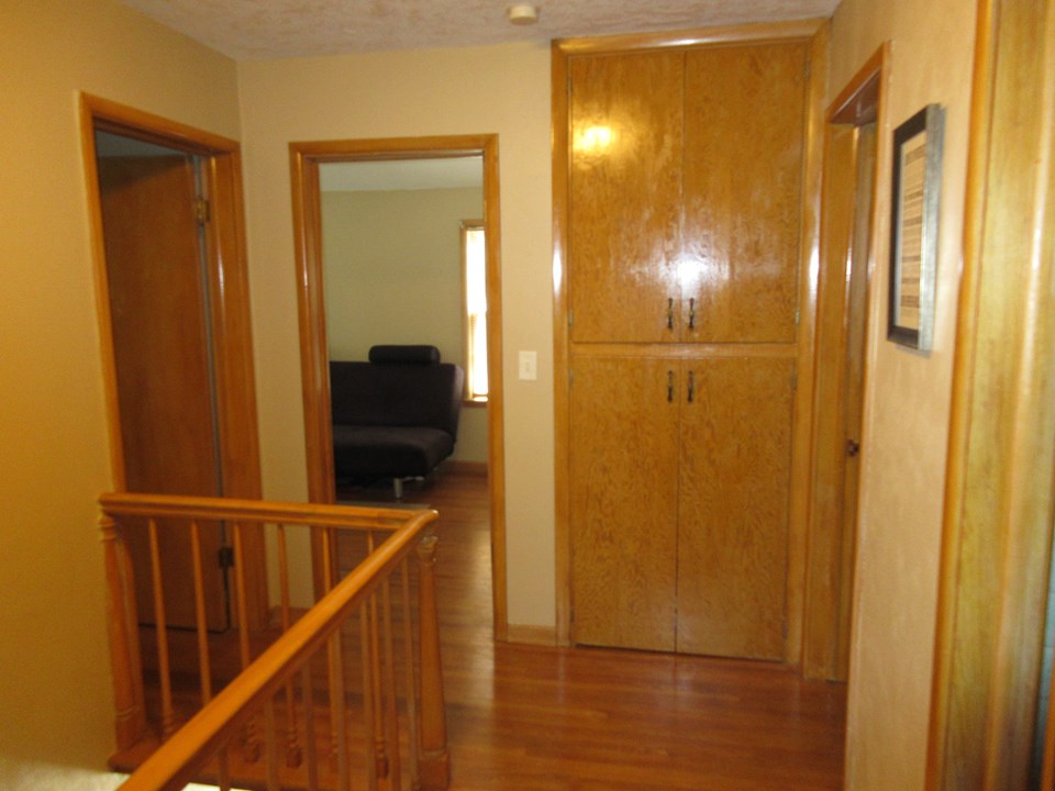 upstairs landing hardwood floors and railing.