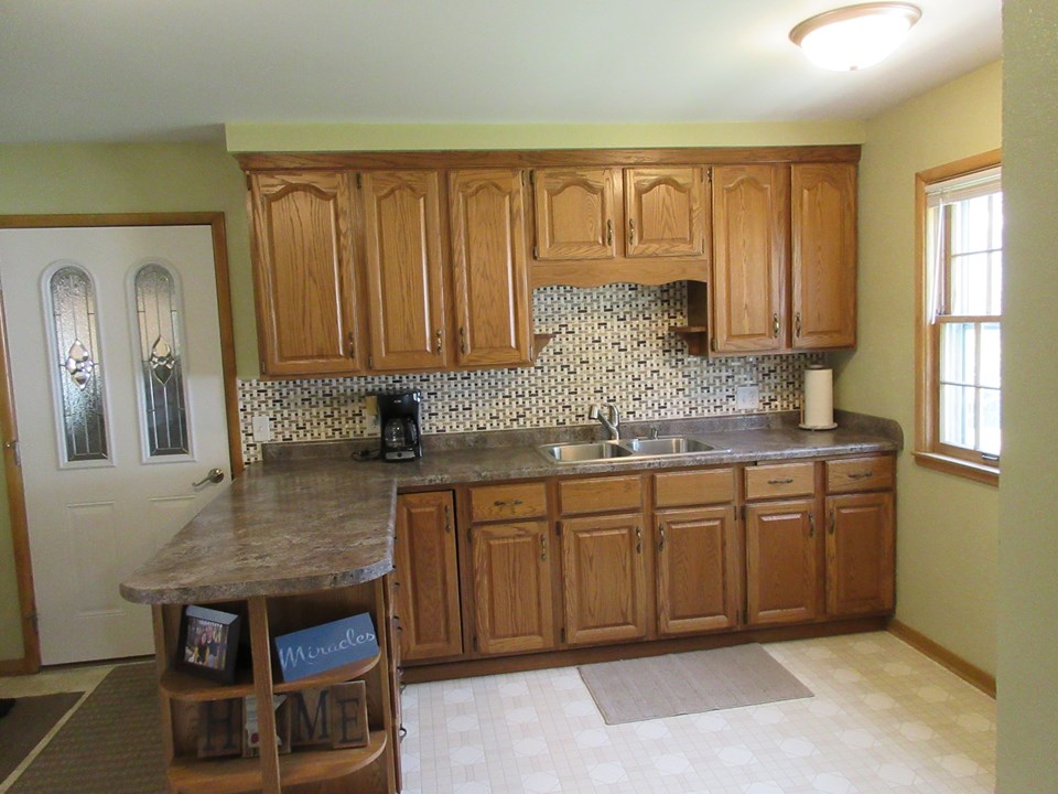 kitchen recently updated with new countertops, backsplash, and sink.