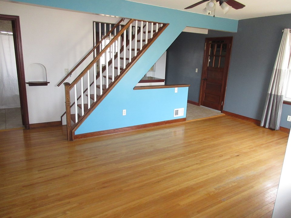 living room open stairway, access to the kitchen and the garage