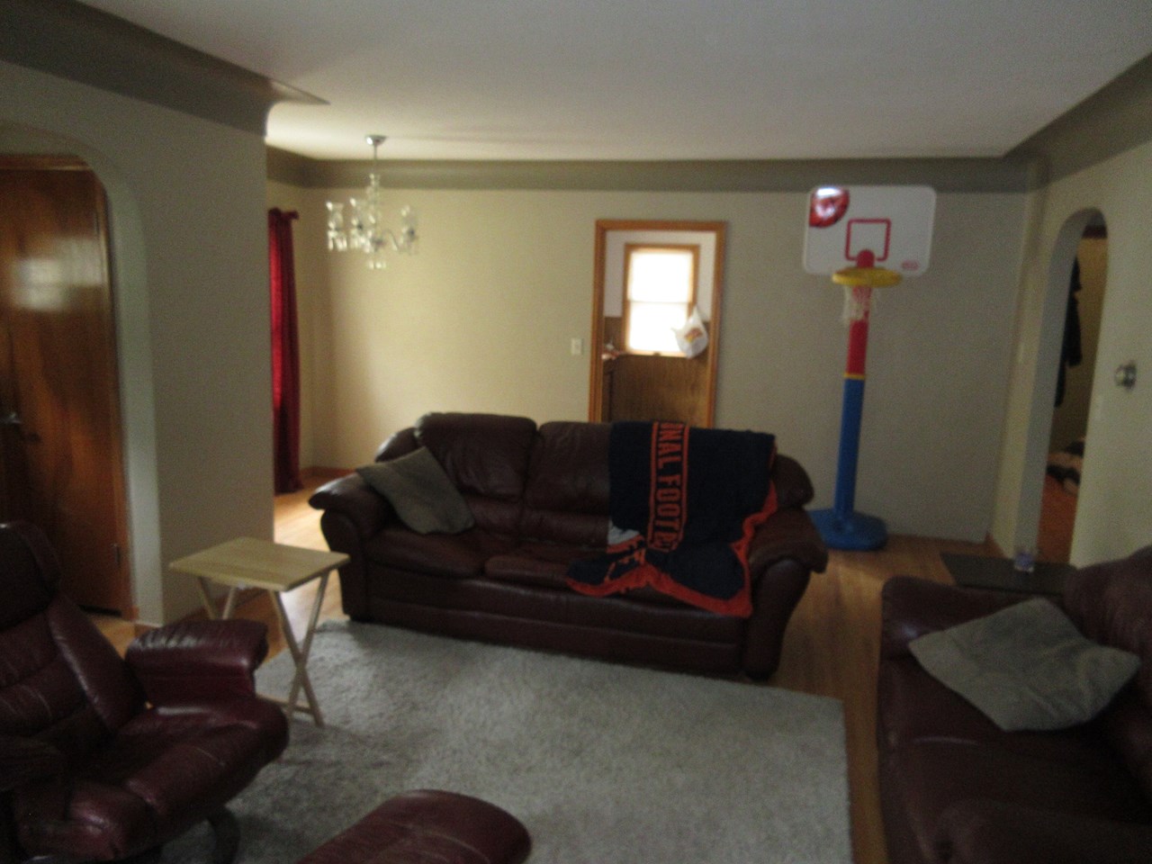 living room very nice hardwood floors and a beautiful coved ceiling.