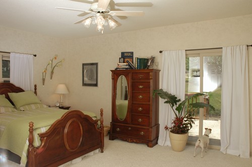 master bedroom  located on main floor, with a walkout to the deck