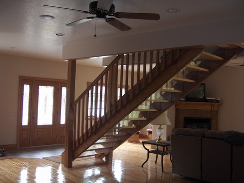 front entry into living area. everything is solid oak. beautiful hardwood floor and open stairway.