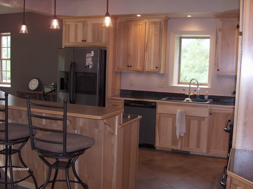 kitchen bar area with stools and electricity.
