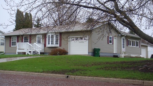 front view newer roof, siding and addition to this stick built home.