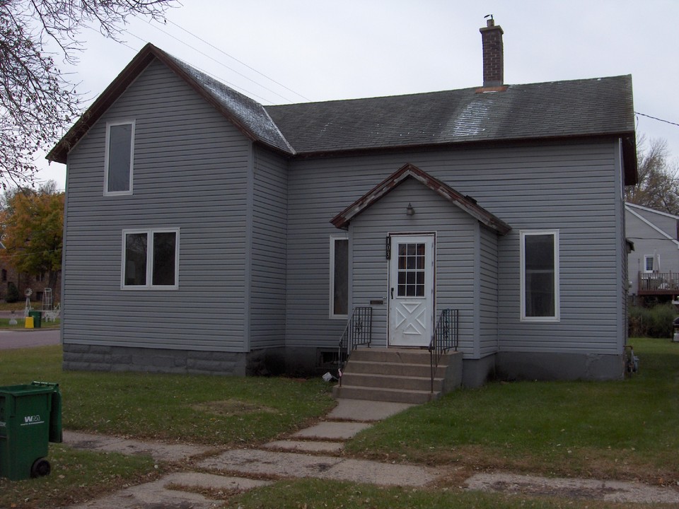 front view notice the new permanent siding and new windows.