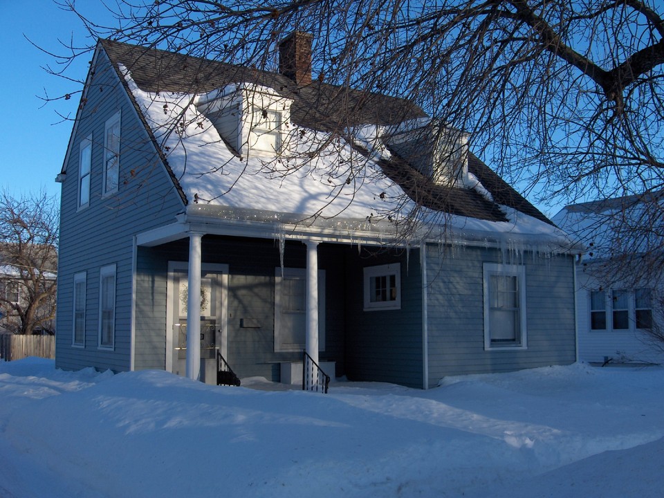 front of house small porch to sit on. newer siding and shingles.