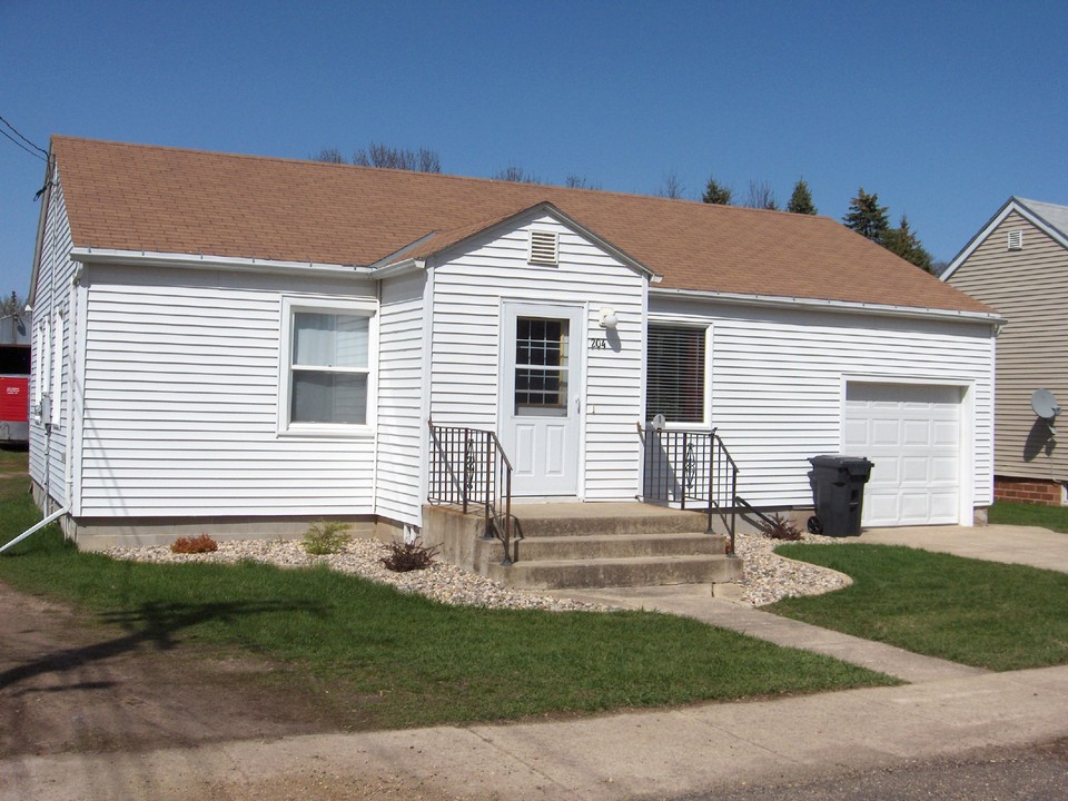 front of house nice siding, roof, and windows. attached garage with opener.