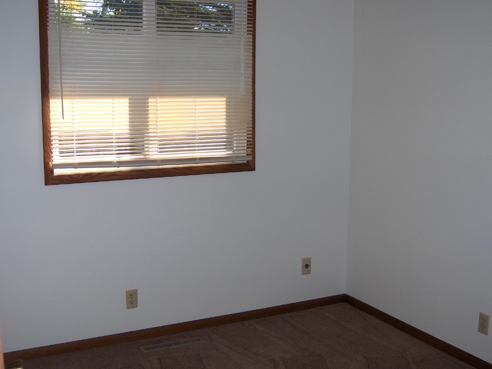 bedroom three with a cedar lined closet and new carpet