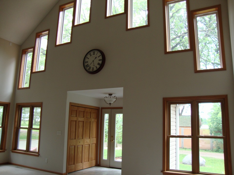 living room with vaulted ceilings and nice windows