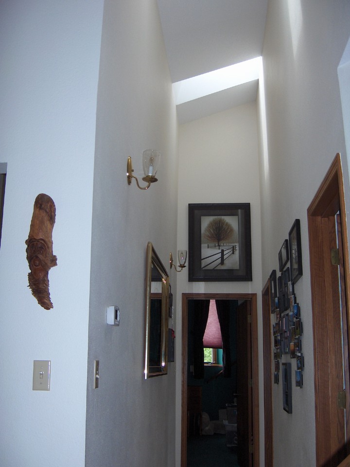 hallway to bedroom vaulted ceilings and skylights