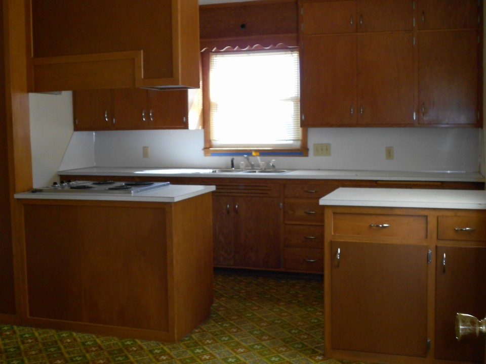 kitchen this photo is taken from the dining room that is large. lots of potential to be opened up.