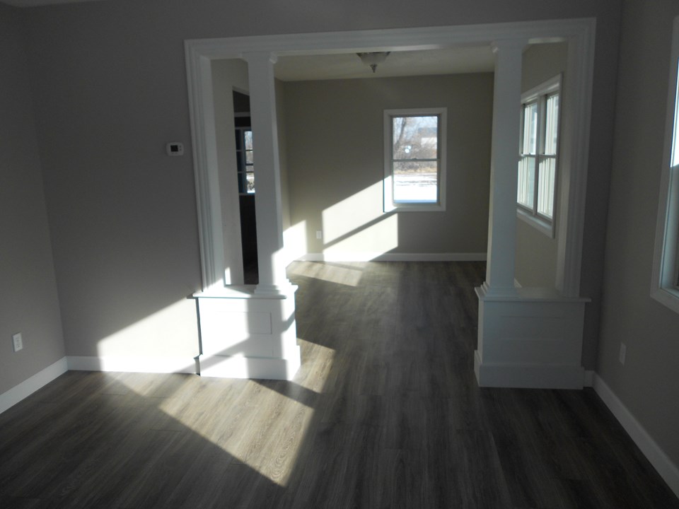 living and dining rooms solid wood trim. new paint. pergo laminate floors. very open plan.