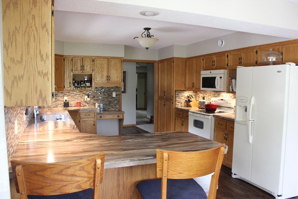 kitchen lots of cupboards and counterspace. eat in breakfast bar area.