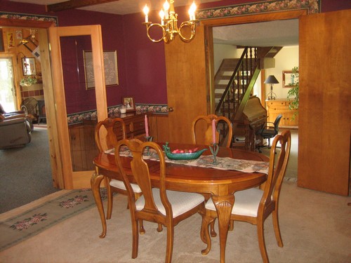 formal dining room notice the open stairway and beautiful doors