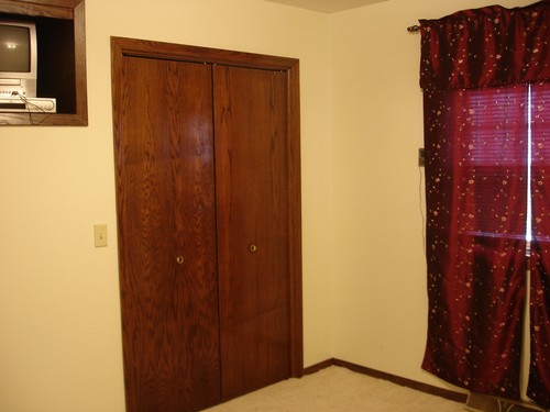 one of three bedrooms brand new capreting for warmth, closet, window, and built in tv shelf.