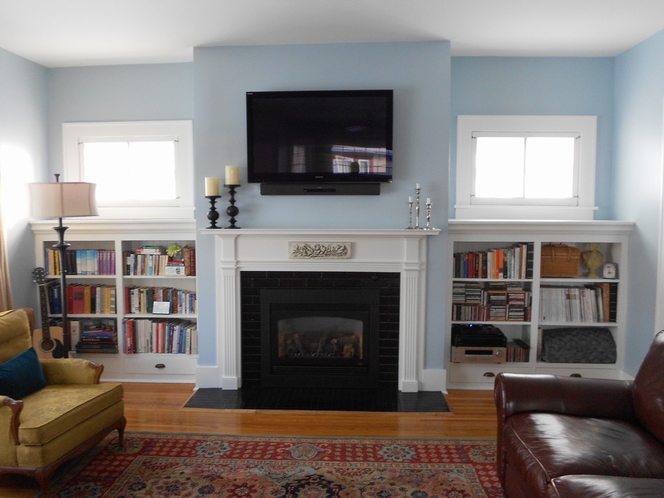 living room newer kozy heat gas fireplace, hardwood floors, character windows, built in shelves