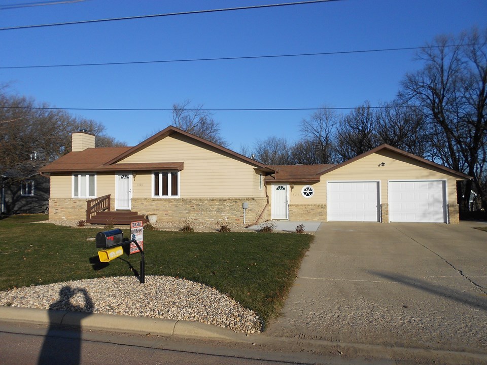 front of home some newer landscaping and cement.  two car attached garage.