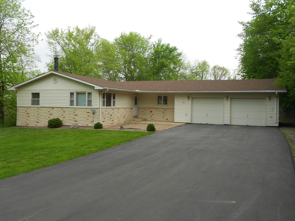 front of home newer siding, shingles, and driveway.  very nice landscaping.