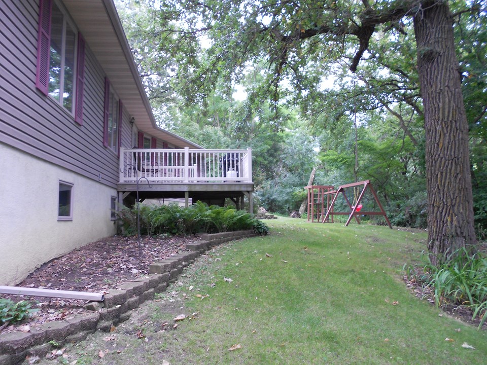 side yard permanent decking, swing set, privacy.  lots more yard around the corner to the back.