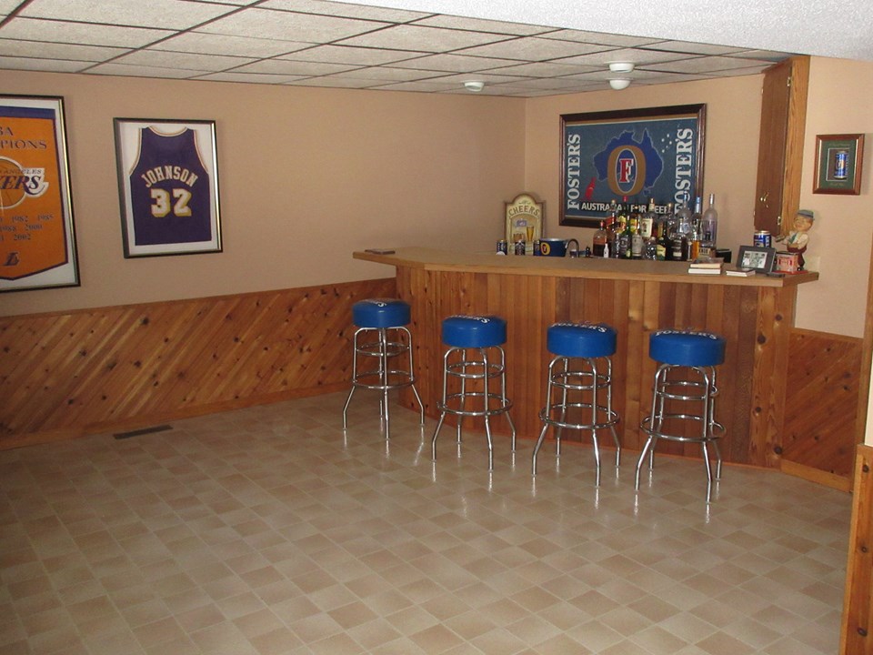 bar in basement right off of the family room, with running water