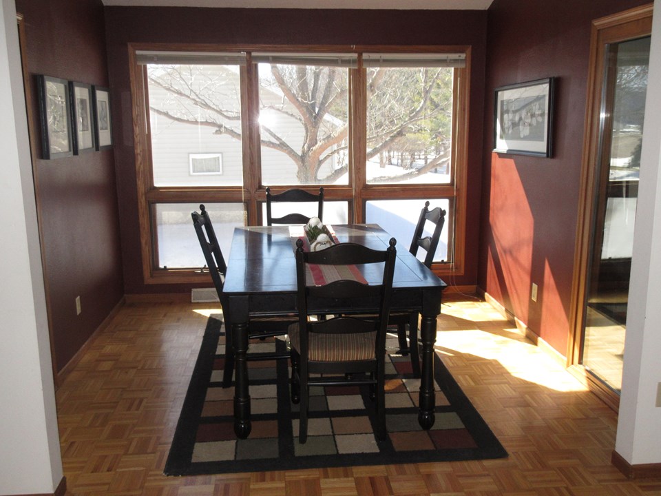 formal dining room wood floor and large windows
