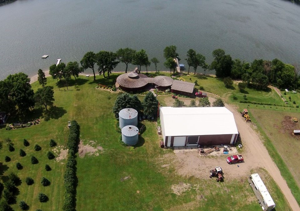 aerial view of property 3 acres and 355 feet of shoreline.  approx 40 feet of sandy beach.  unique round structure.   roof new in 2005.  50 x 80 shed.