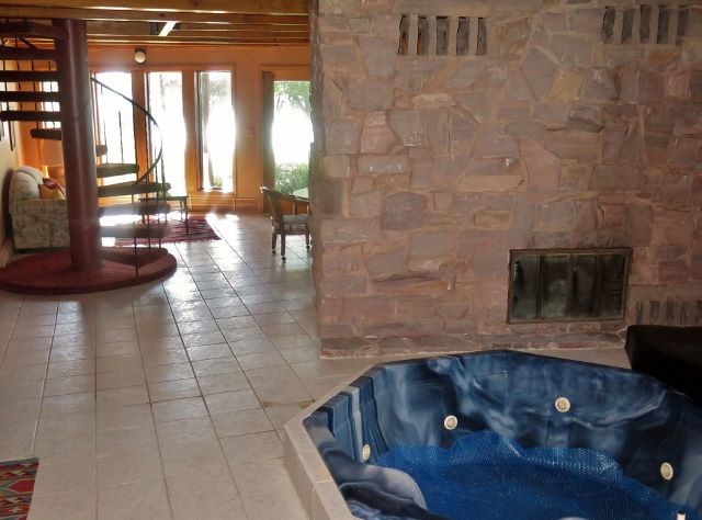 hot tub area with jasper granite fireplace