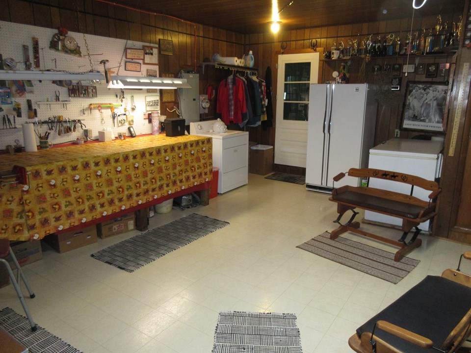 large utility room located between the kitchen and the garage.