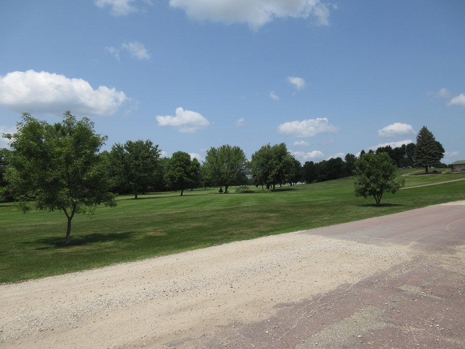 view from the driveway number one fairway of loon lake golf course.  the clubhouse is to the right.