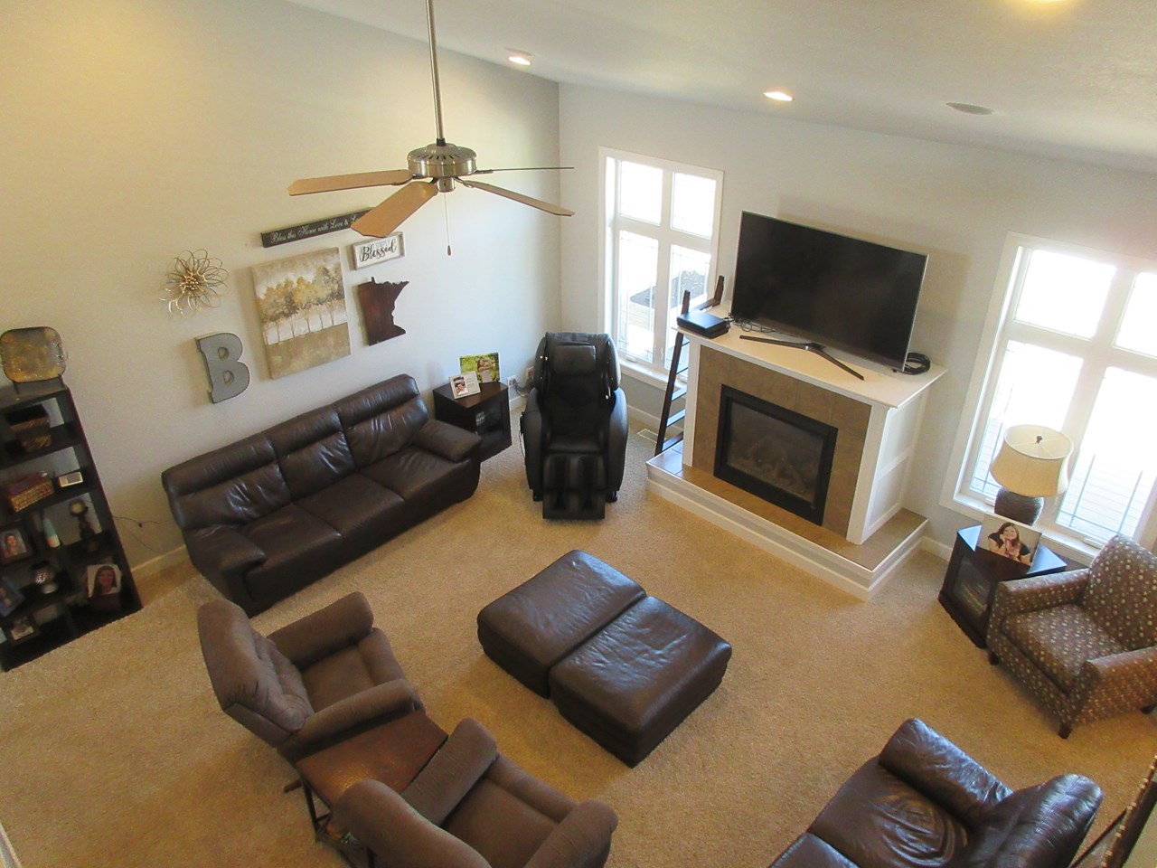 living room from top of open stairway.   kozy heat gas fireplace