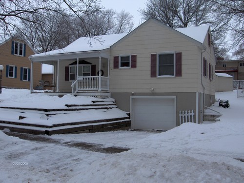 front of house view of the garage and a the shed in the backyard