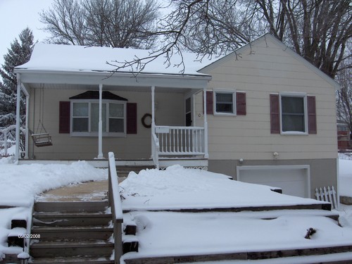 front of house notice the landscaping, deck, and swing