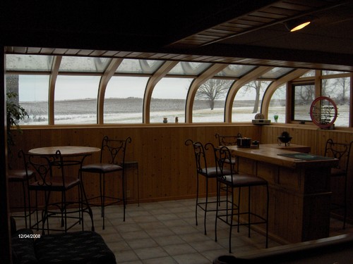 sunroom built in bar, tile floor, and lots of window light.