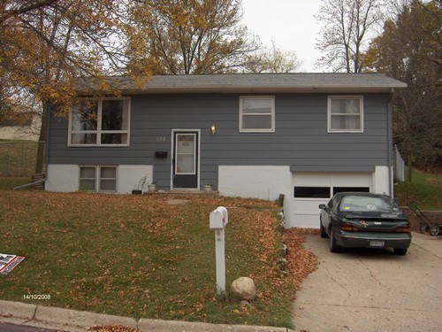 front of house new paint, tuck under garage, fence in backyard