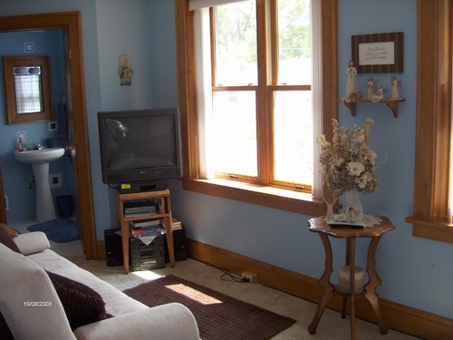 small tv room or bedroom with 1/2 bath