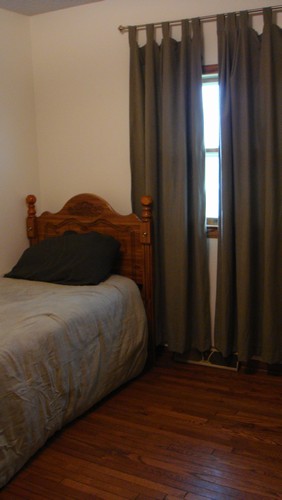 one of three bedrooms hardwood floor, closet, and window.