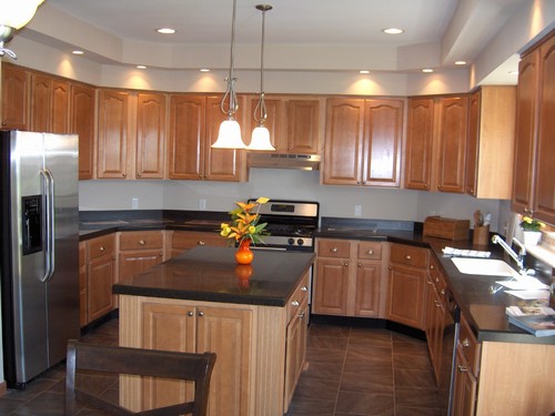 kitchen very well lit, lots of storage, and solid surface countertops