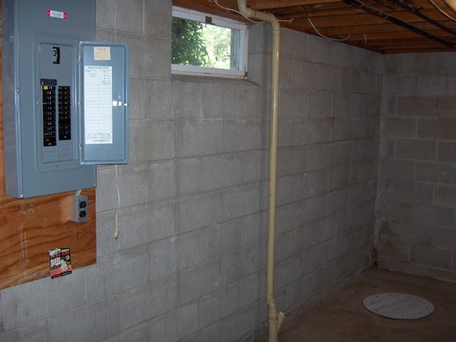 utility area 200 amp breakers, sump hole that is dry and never used.