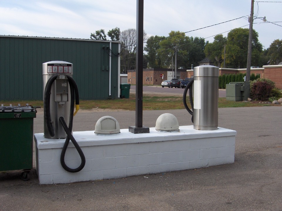 two vacuum cleaners and waste cans.