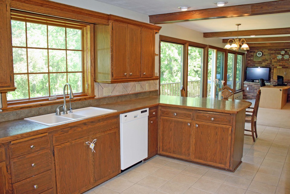 kitchen ceramic tile floor. newer cupboards.  lots of windows overlooking the backyard.